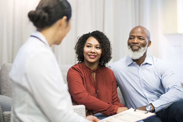 Doctor discussing with patient on sofa in clinic paid clinical trials in miami